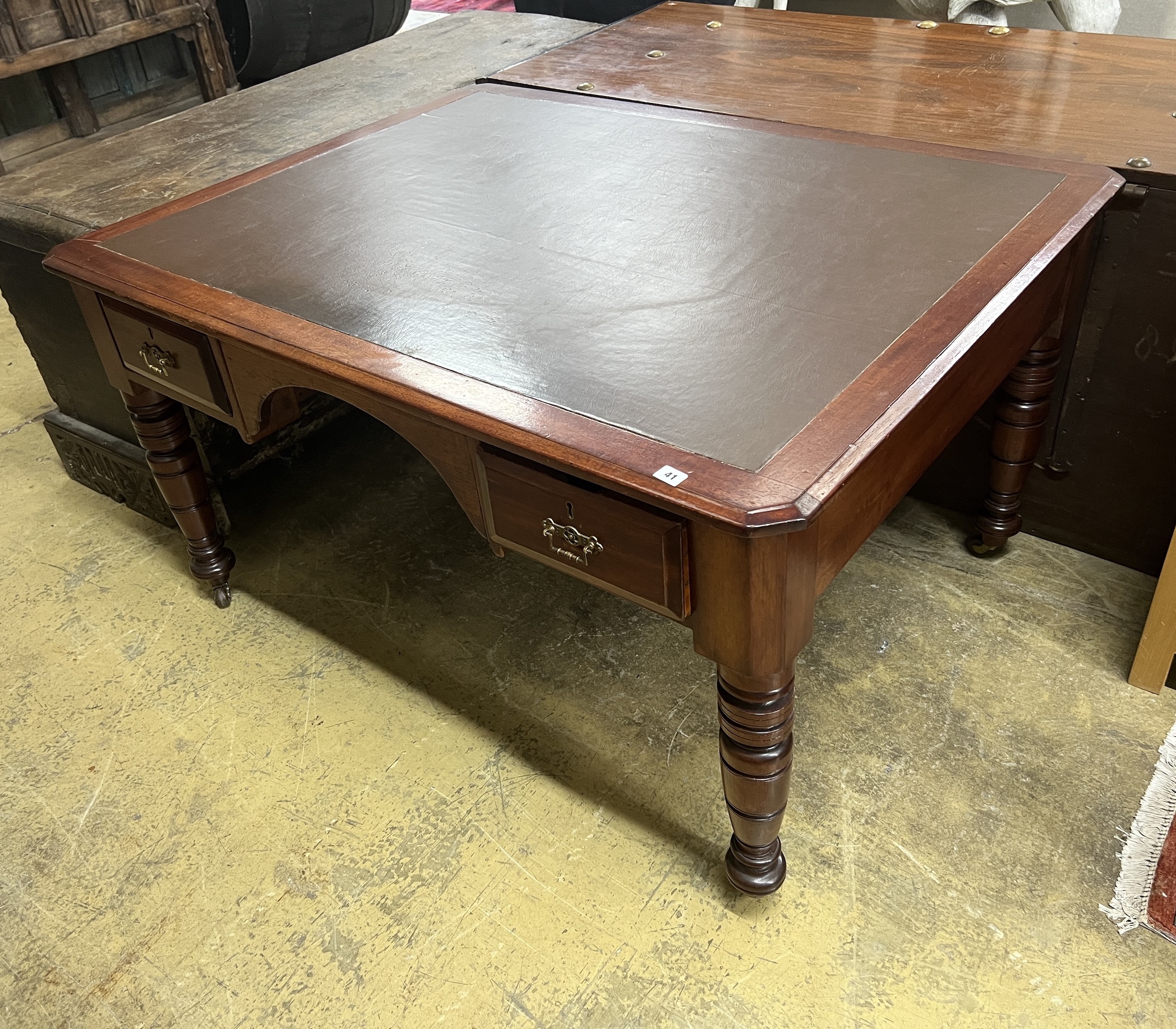 A late Victorian mahogany and cedar kneehole writing table, width 137cm, depth 107cm, height 75cm